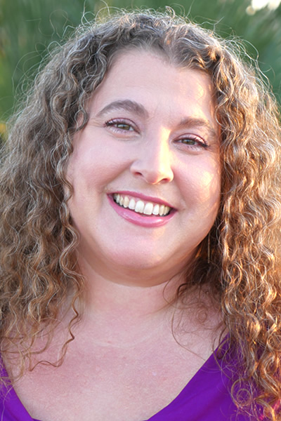 person wearing purple and smiling